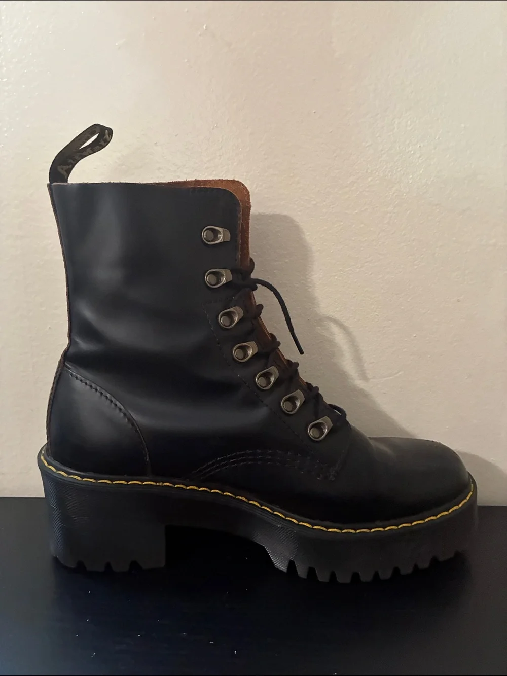 Dr. Martens Leona platform boots featuring a black smooth leather size 9